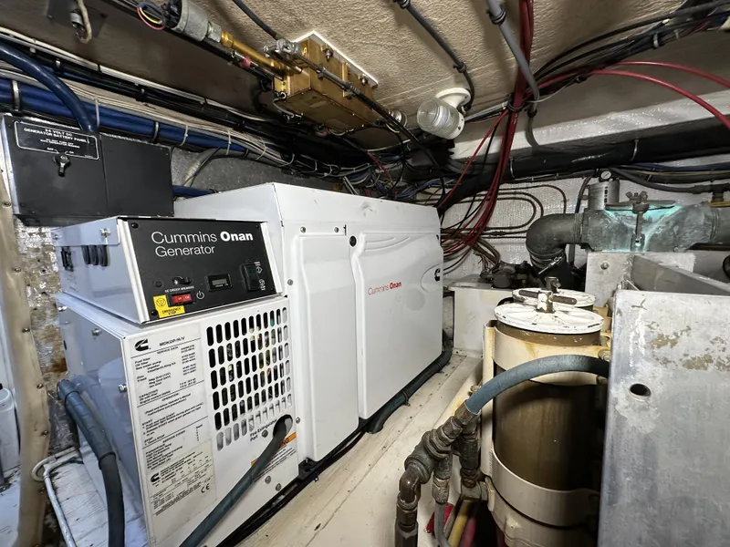 Slide: The Image of Cummins Onan generator in the engine room of a 1992 Hatteras 50 Convertible yacht. - 40