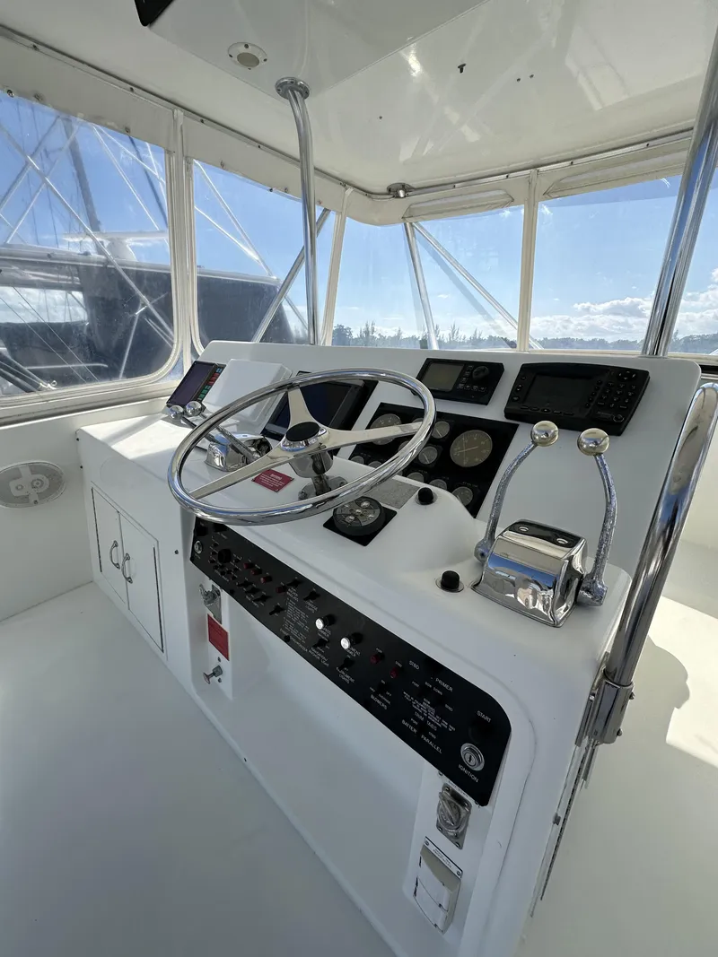 Slide: The Image of 1992 Hatteras 50 Convertible yacht helm station with modern controls and panoramic windows. - 48