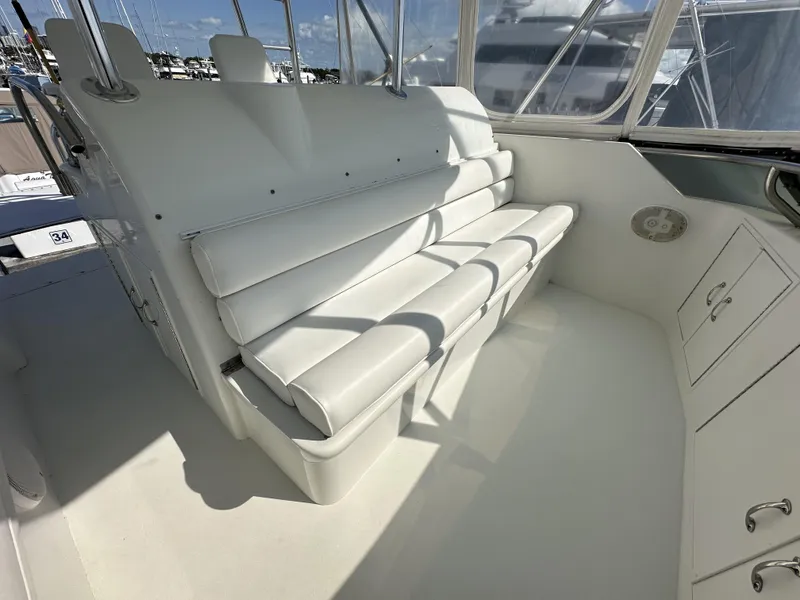 Slide: The Image of Interior seating of 1992 Hatteras 50 Convertible yacht with white cushioned bench. - 49