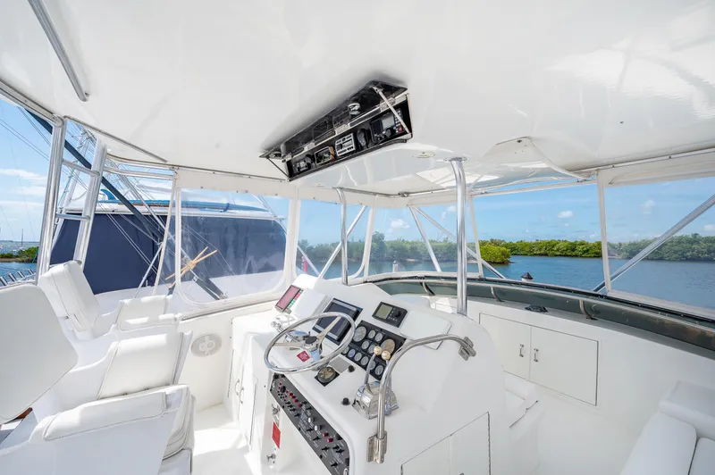 Slide: The Image of 1992 Hatteras 50 Convertible yacht helm with navigation equipment and scenic water view. - 5