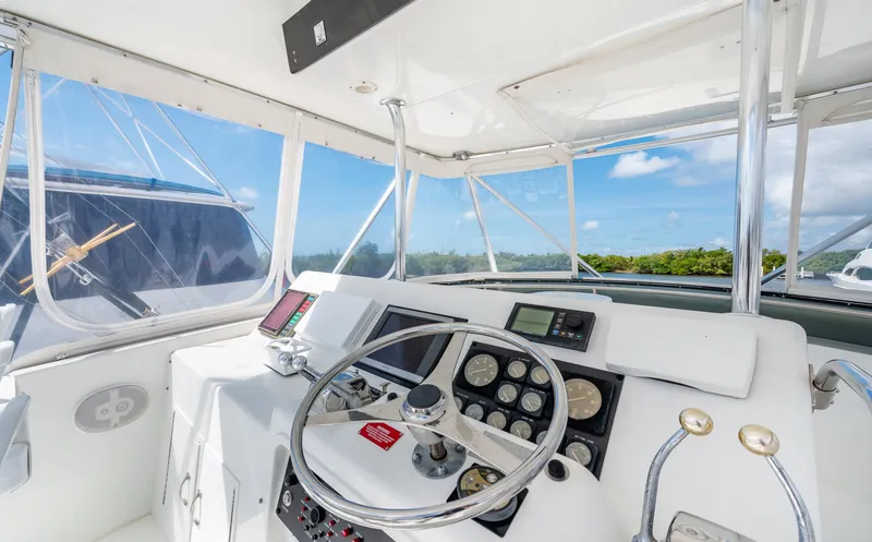Slide: The Image of Cockpit of 1992 Hatteras 50 Convertible yacht with steering wheel and navigation instruments. - 7