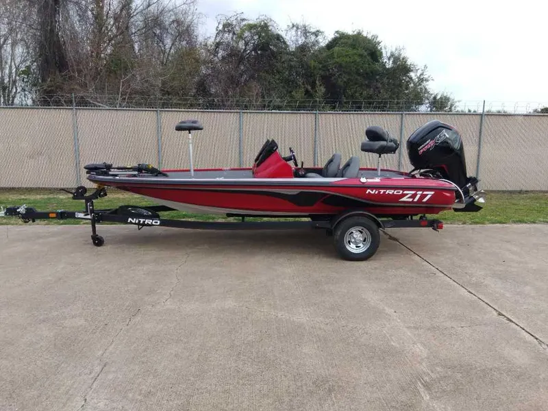 Slide: The Image of 2024 Nitro Z17 fishing boat on trailer, red and black design. - 0