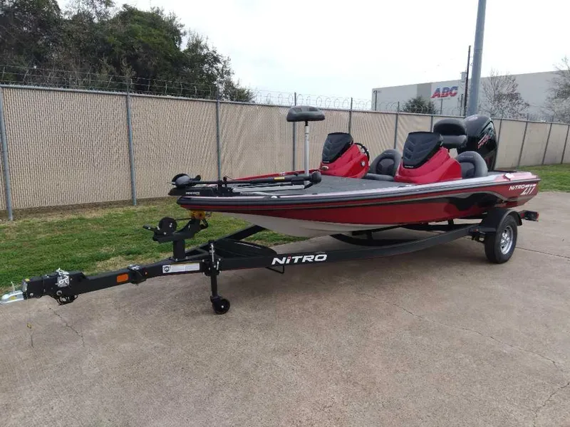 Slide: The Image of 2024 Nitro Z17 fishing boat on trailer, red and black design. - 1