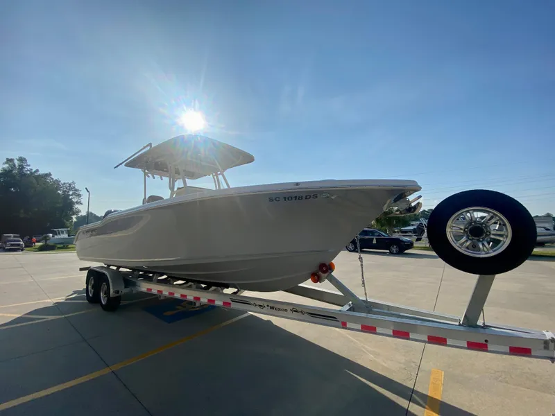 Slide: The Image of 2022 Key West 263 FS boat on a trailer in a parking lot. - 2