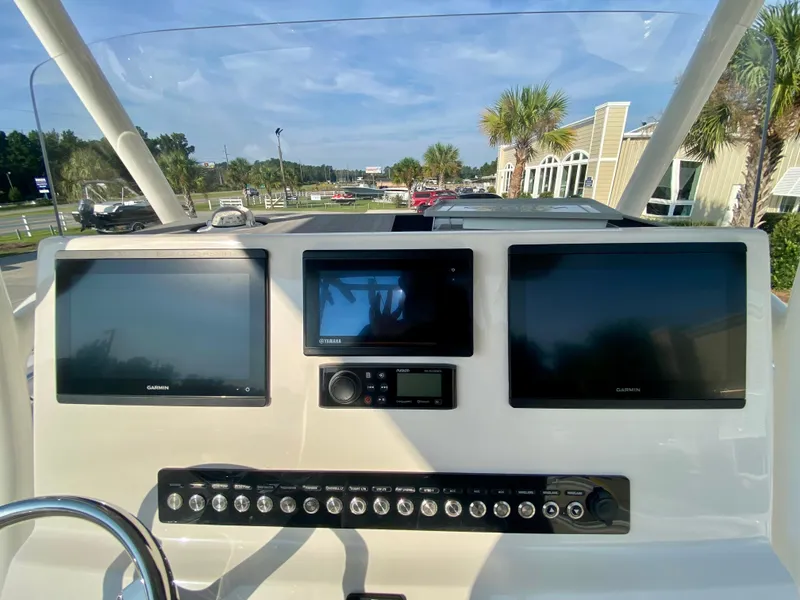 Slide: The Image of 2022 Key West 263 FS boat dashboard with Garmin displays and control panel. - 24