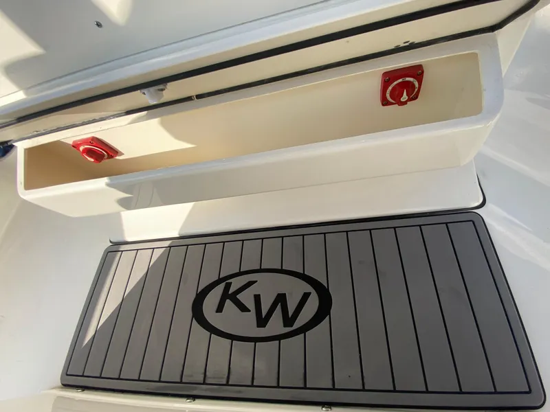 Slide: The Image of 2022 Key West 263 FS boat storage compartment and KW logo mat. - 27