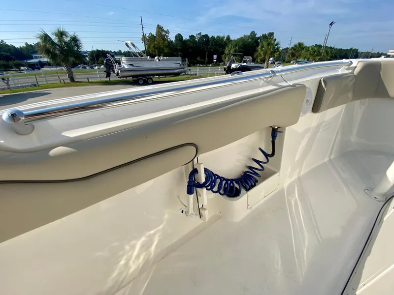 Slide: The Image of 2022 Key West 263 FS boat interior with coiled blue hose and rail. - 33
