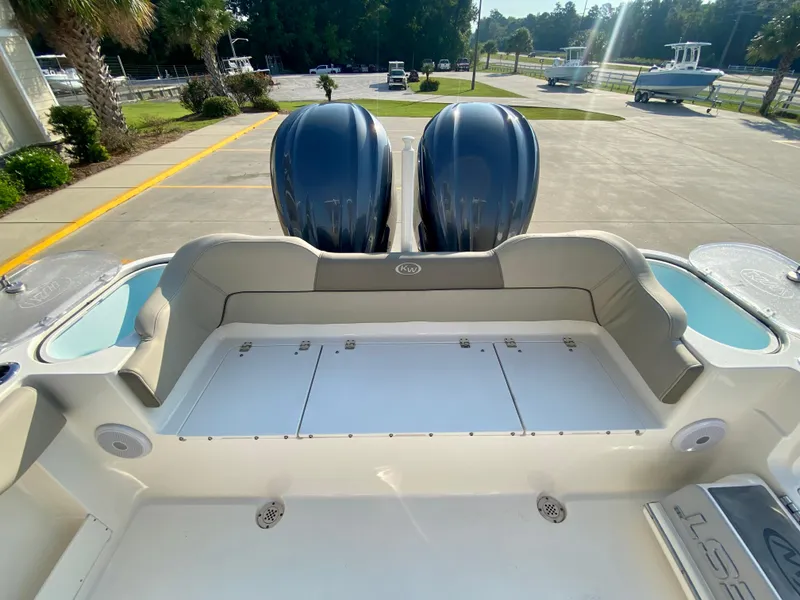 Slide: The Image of 2022 Key West 263 FS boat with dual outboard engines, spacious deck, and seating area. - 10