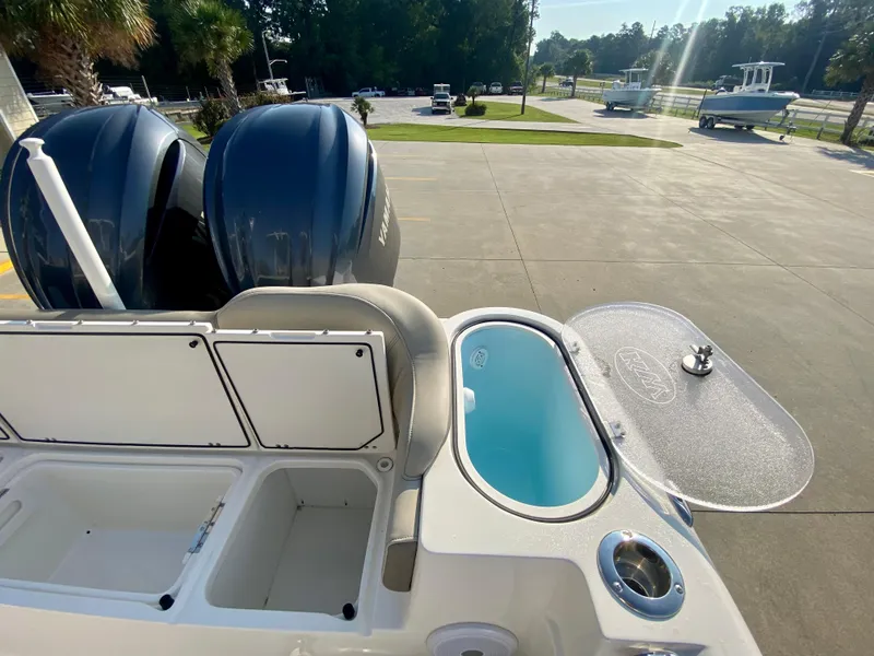 Slide: The Image of 2022 Key West 263 FS boat with dual engines and open storage compartments. - 13
