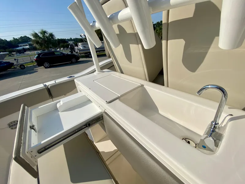 Slide: The Image of 2022 Key West 263 FS boat with sink and storage compartments. - 19