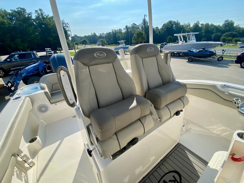 Slide: The Image of 2022 Key West 263 FS boat with dual captain's chairs in a marina. - 21