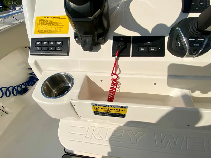 Slide: The Image of 2022 Key West 263 FS boat console with controls and cup holder. - 25