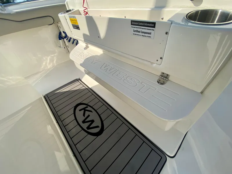 Slide: The Image of 2022 Key West 263 FS boat interior, showing branded flooring and seating. - 26