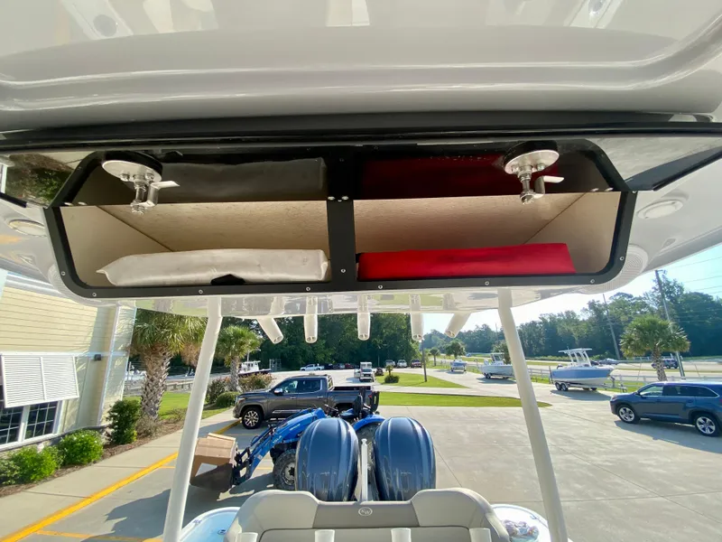 Slide: The Image of 2022 Key West 263 FS boat with overhead storage compartments and dual outboard motors. - 29