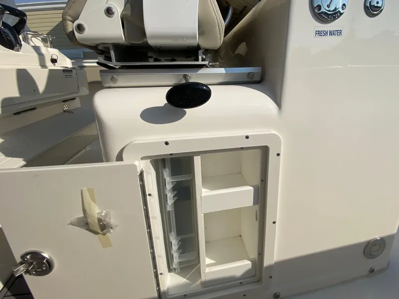 Slide: The Image of 2022 Key West 263 FS boat storage compartment and fresh water access. - 35
