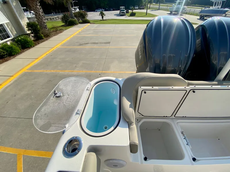 Slide: The Image of 2022 Key West 263 FS boat with dual outboard engines and open storage compartments. - 12