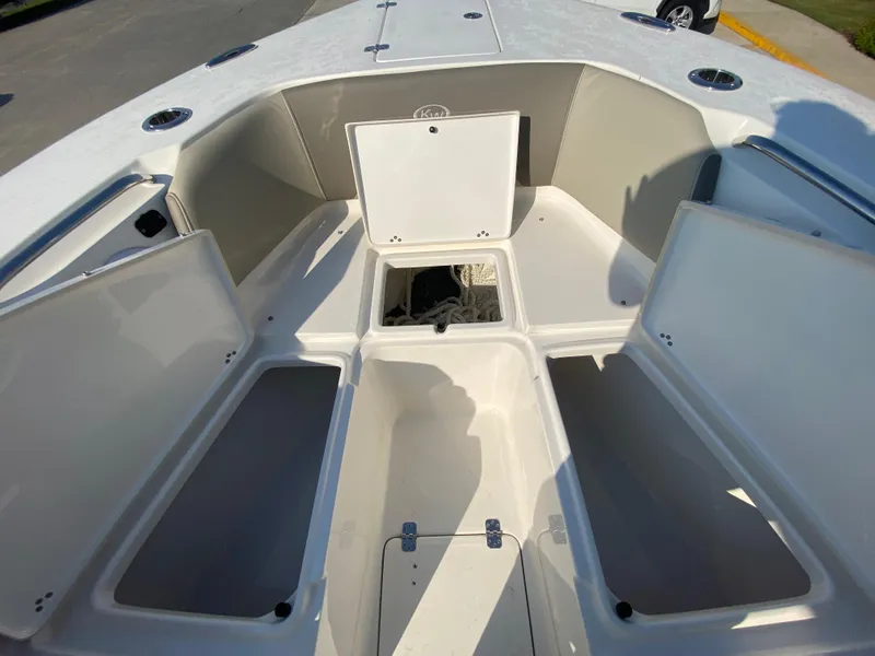 Slide: The Image of 2022 Key West 263 FS boat with open storage compartments. - 44