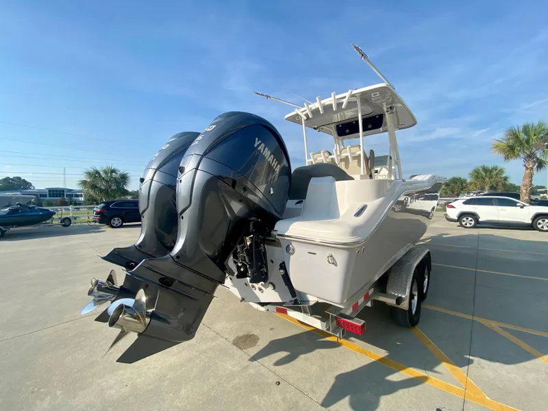 Slide: The Image of 2022 Key West 263 FS boat with twin Yamaha engines in parking lot. - 6
