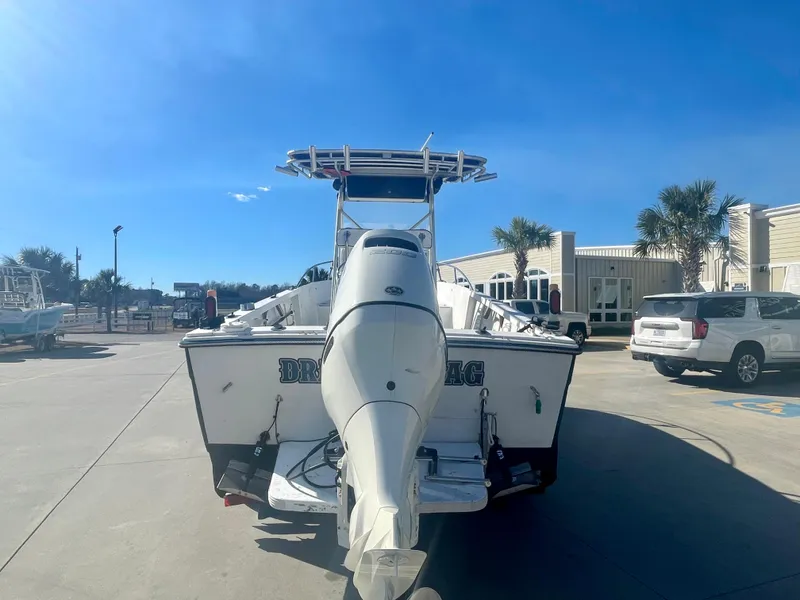 Slide: The Image of 1980 Robalo 2380 boat with outboard motor in marina parking lot. - 2
