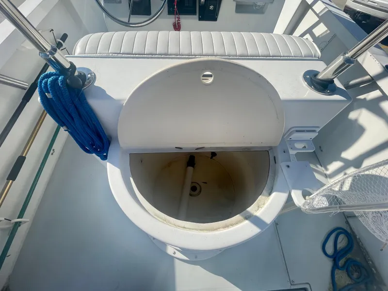 Slide: The Image of 1980 Robalo 2380 boat interior with open storage compartment. - 8