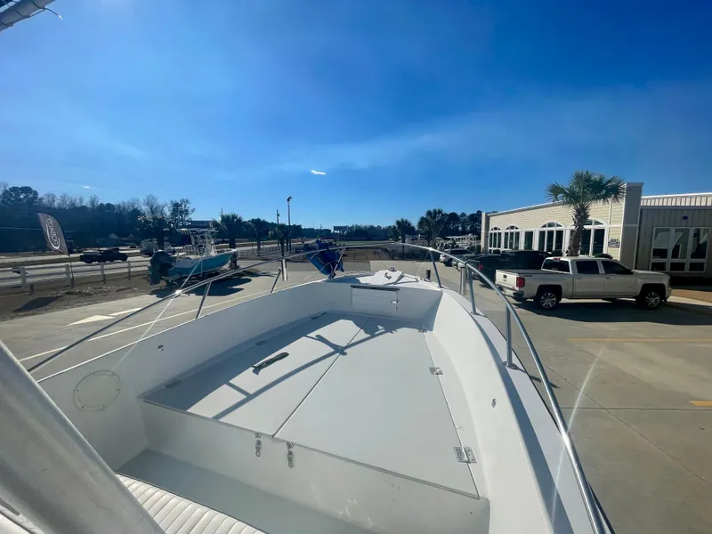 Slide: The Image of 1980 Robalo 2380 boat docked at marina under clear blue sky. - 12