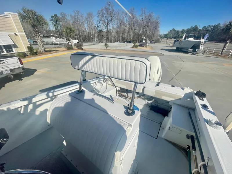Slide: The Image of 1980 Robalo 2380 boat interior with white seating and steering wheel. - 7