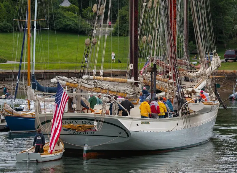 Slide: The Image of A 1962 Gamage Coastal Gaff Rigged Schooner docked with people on board. - 12