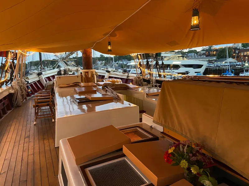 Slide: The Image of Interior of 1962 Gamage Coastal Gaff Rigged Schooner with wooden deck and covered seating area. - 13