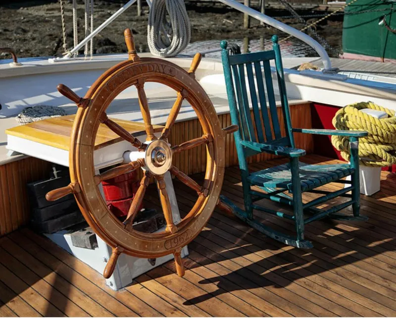 Slide: The Image of Wooden ship wheel and rocking chair on 1962 Gamage Coastal Gaff Rigged Schooner deck. - 20