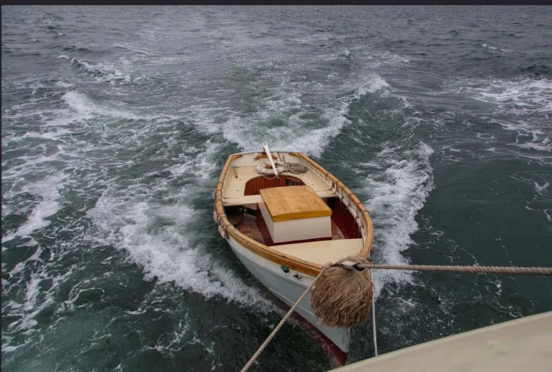 Slide: The Image of A 1962 Gamage Coastal Gaff Rigged Schooner towed on choppy waters. - 25