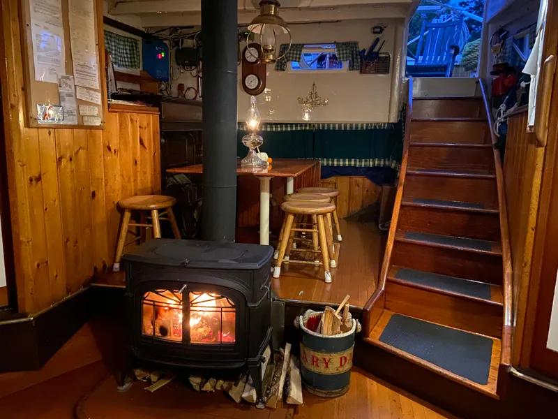 Slide: The Image of Cozy interior of 1962 Gamage Coastal Gaff Rigged Schooner with wood stove and wooden decor. - 29