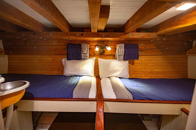 Slide: The Image of Cozy cabin interior of 1962 Gamage Coastal Gaff Rigged Schooner with twin beds and wooden beams. - 37