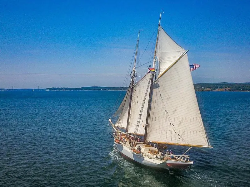 Slide: The Image of Gamage Coastal Gaff Rigged Schooner sailing on open sea, 1962 model, under clear blue sky. - 9