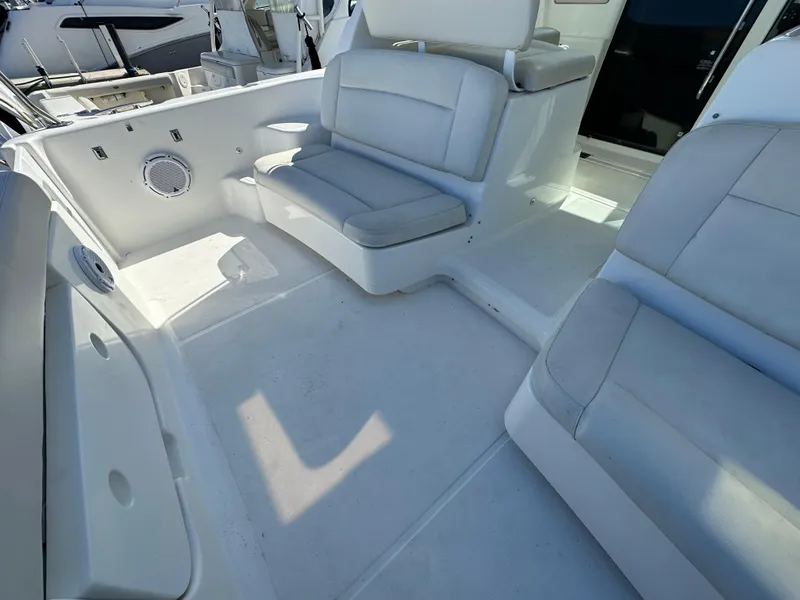 Slide: The Image of 2004 Tiara Yachts 3600 Sovran cockpit seating area with white upholstery. - 10