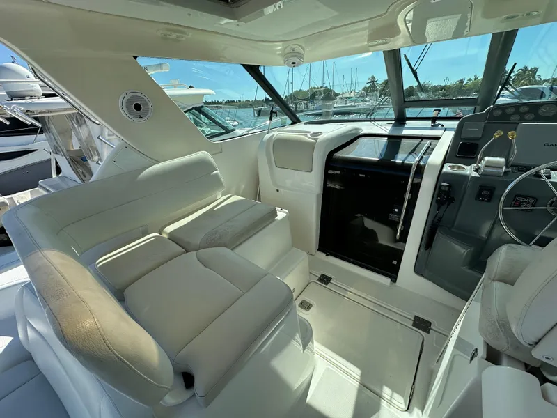 Slide: The Image of Interior cockpit of 2004 Tiara Yachts 3600 Sovran with plush seating and navigation controls. - 11