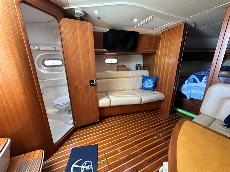 Slide: The Image of Interior of 2004 Tiara Yachts 3600 Sovran with wooden flooring and beige seating. - 19