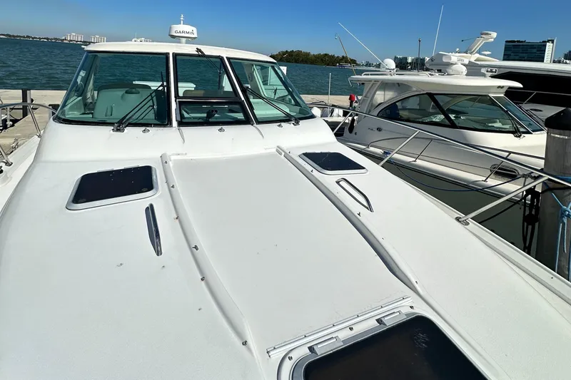 Slide: The Image of 2004 Tiara Yachts 3600 Sovran docked, front deck view with ocean backdrop. - 29