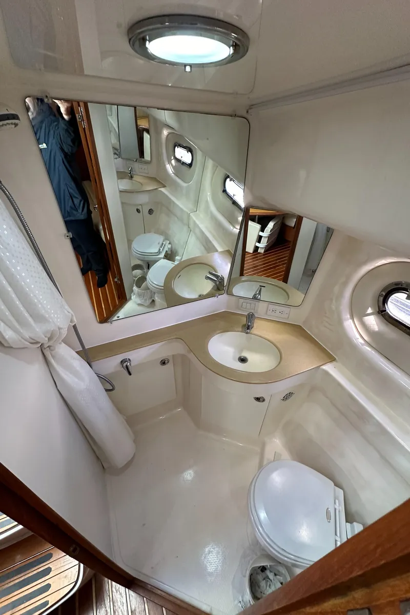 Slide: The Image of 2004 Tiara Yachts 3600 Sovran bathroom with sink, toilet, and mirror. - 32