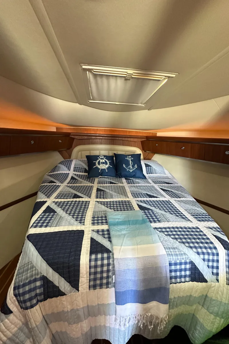 Slide: The Image of 2004 Tiara Yachts 3600 Sovran cabin with nautical-themed bedding and pillows. - 33