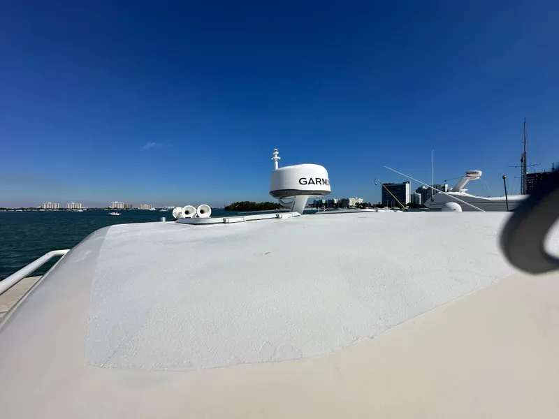 Slide: The Image of 2004 Tiara Yachts 3600 Sovran with Garmin radar on deck, clear blue sky background. - 6