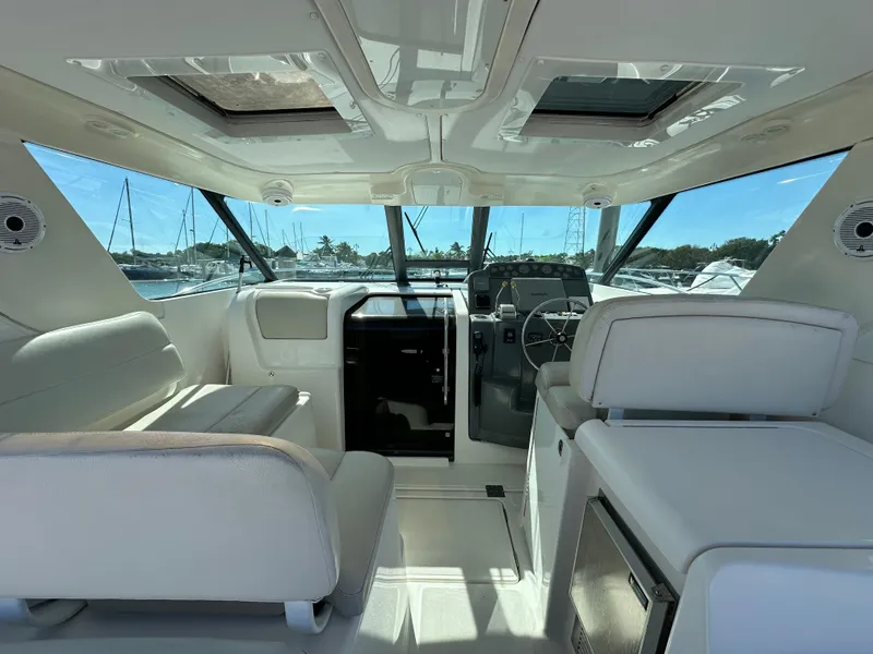 Slide: The Image of Interior of a 2004 Tiara Yachts 3600 Sovran, featuring helm and seating area. - 9
