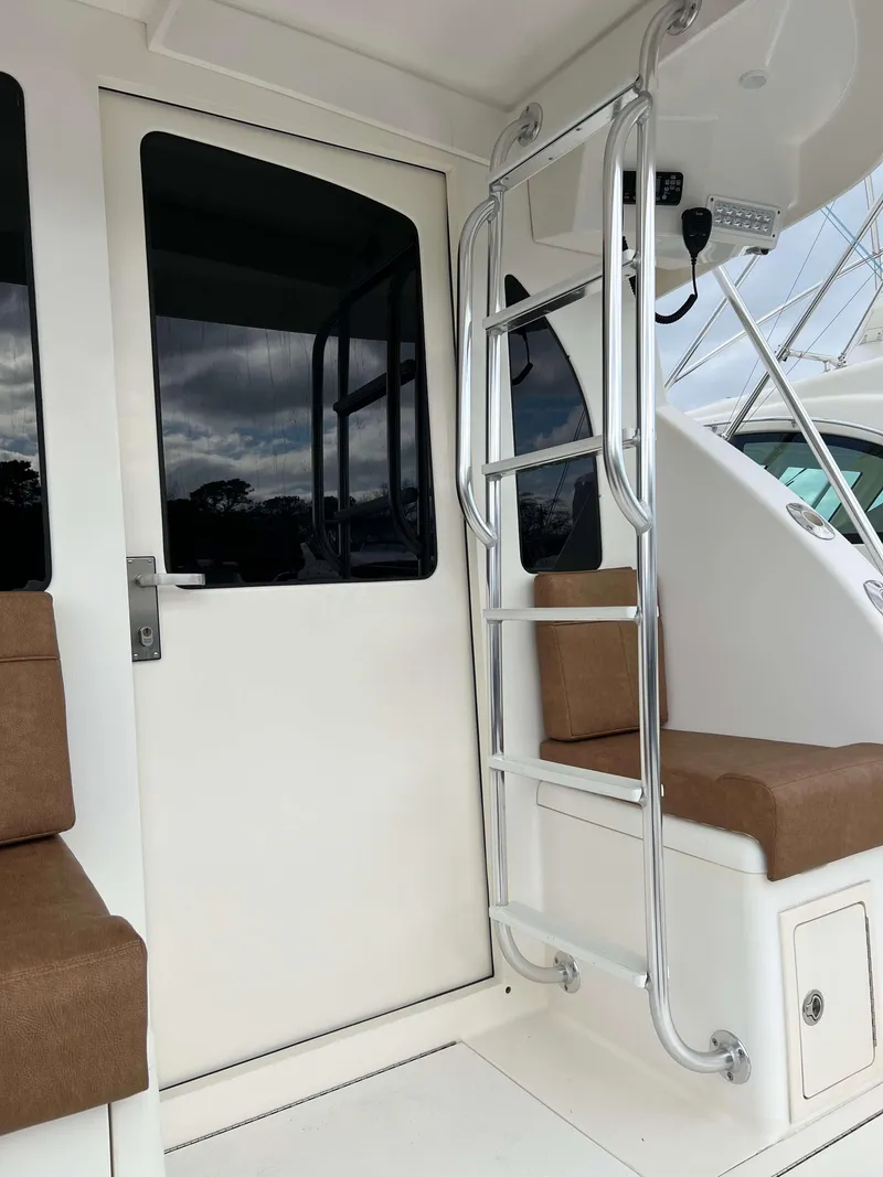 Slide: The Image of 2021 Henriques 50 Sportfisherman boat interior with ladder and seating. - 10