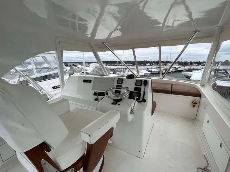 Slide: The Image of Helm station of 2021 Henriques 50 Sportfisherman with white captain's chair and navigation equipment. - 13