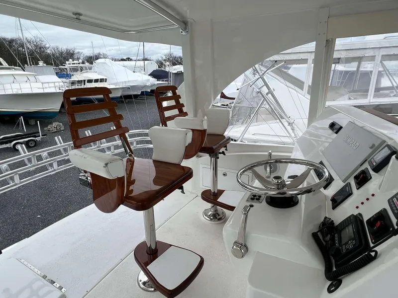 Slide: The Image of 2021 Henriques 50 Sportfisherman helm with dual captain chairs and modern controls. - 15