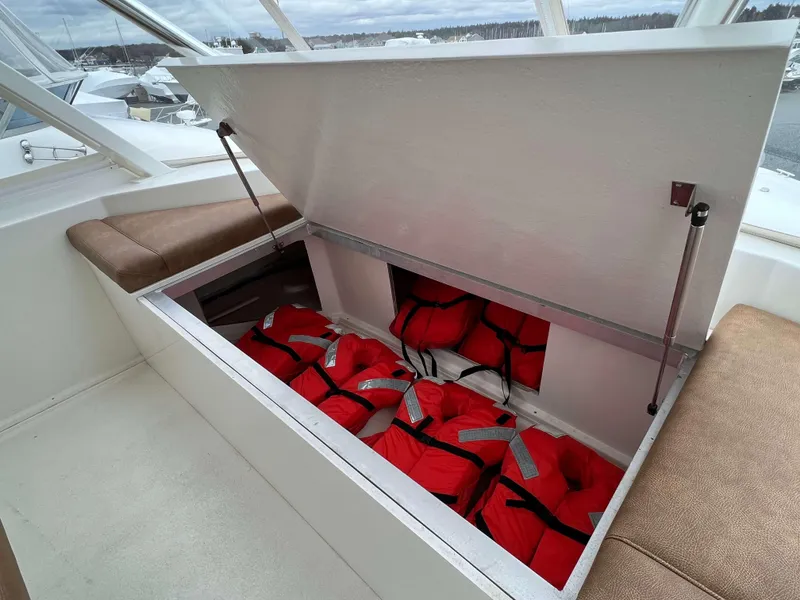 Slide: The Image of Storage compartment with life jackets on a 2021 Henriques 50 Sportfisherman boat. - 20