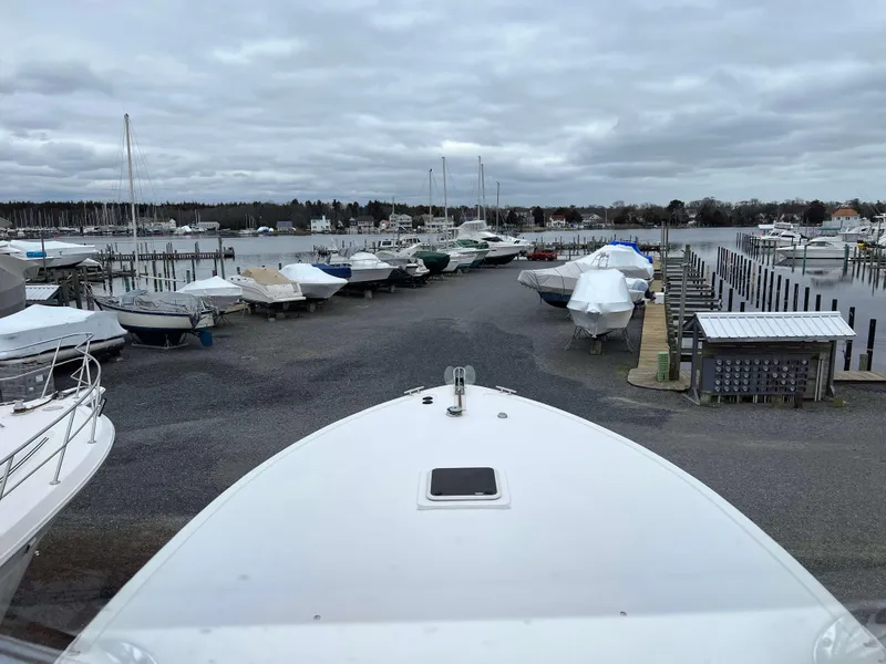 Slide: The Image of 2021 Henriques 50 Sportfisherman docked at a marina with other boats. - 21