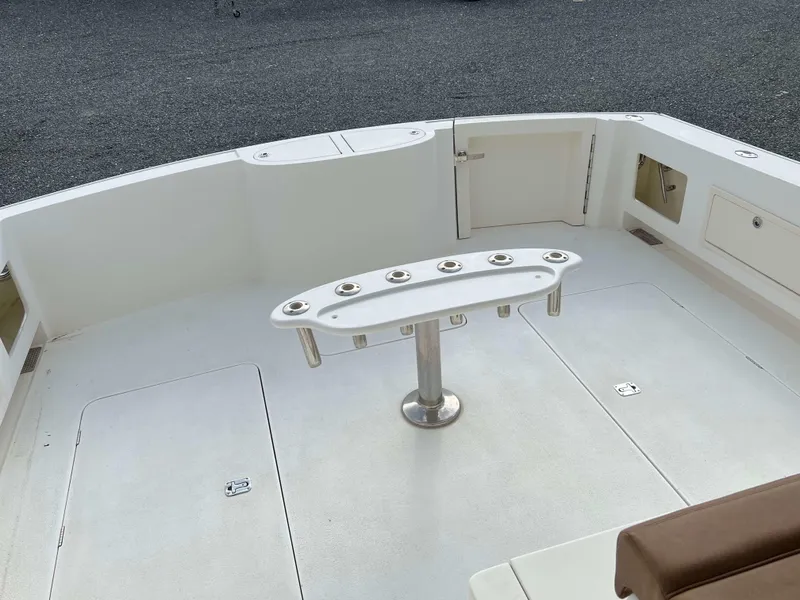 Slide: The Image of Henriques 50 Sportfisherman 2021 boat deck with rod holders and storage compartments. - 23