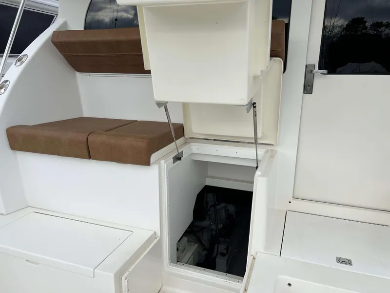 Slide: The Image of 2021 Henriques 50 Sportfisherman engine compartment access with seating area. - 24