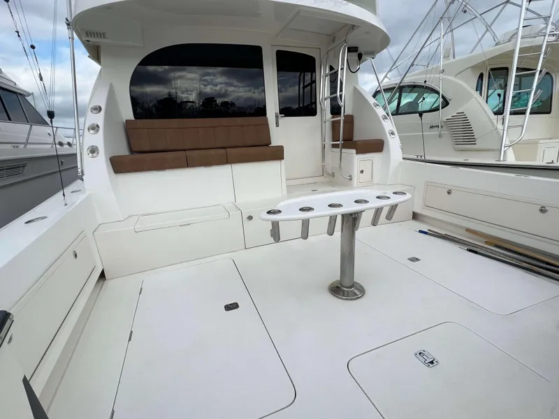 Slide: The Image of Henriques 50 Sportfisherman 2021 boat deck with seating and fishing rod holders. - 3