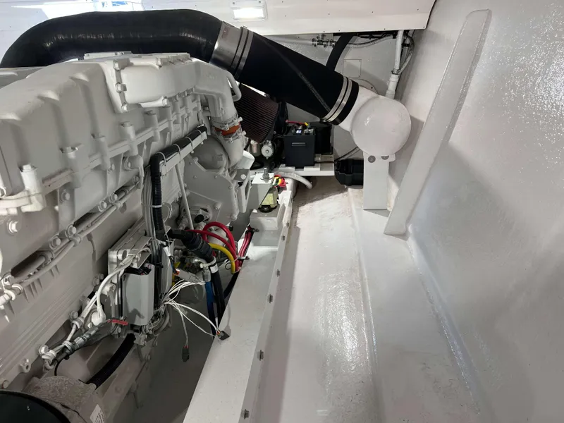 Slide: The Image of Engine room of a 2021 Henriques 50 Sportfisherman boat, showcasing the engine and components. - 33